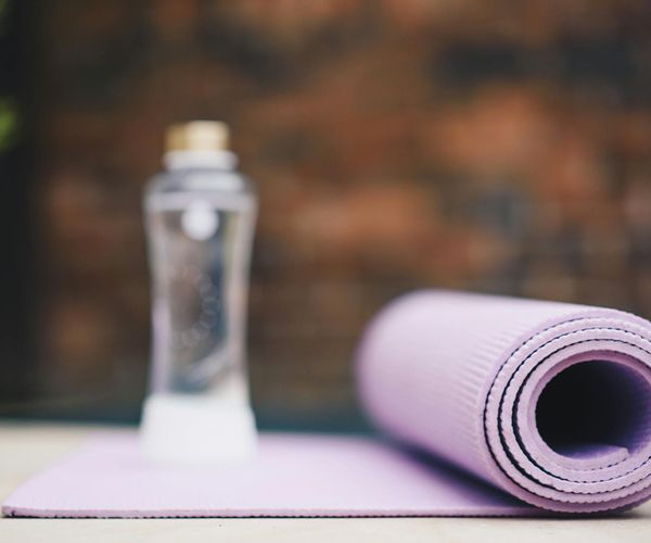 A serene scene with yoga mats and props in a bright studio.